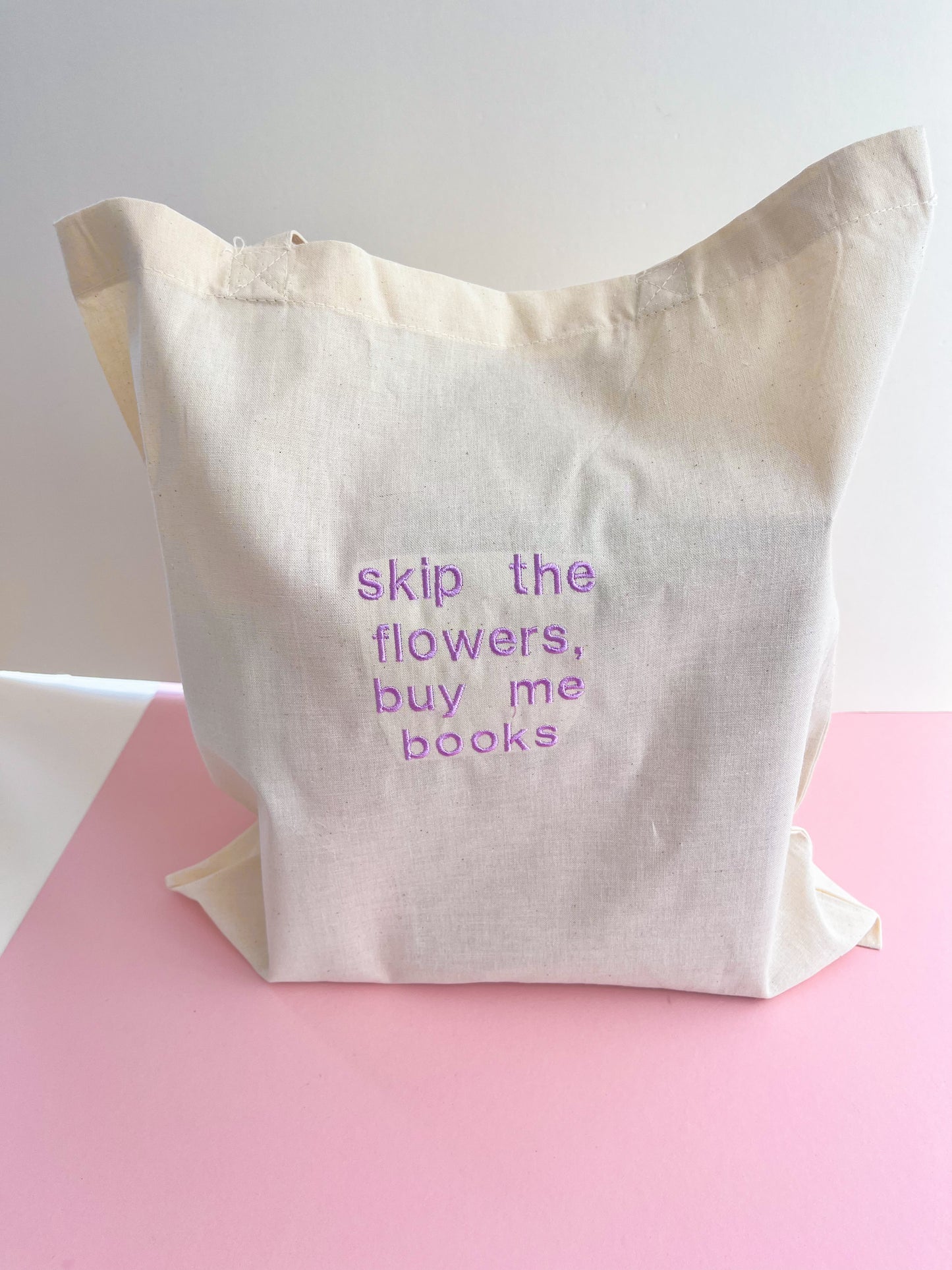 skip the flowers, buy me books embroidered tote bag