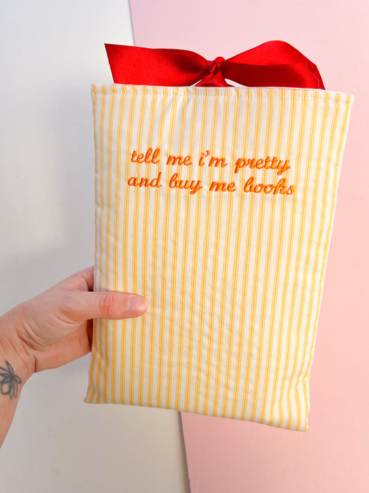 tell me I’m pretty and buy me books (orange text) - embroidered paperback sleeve