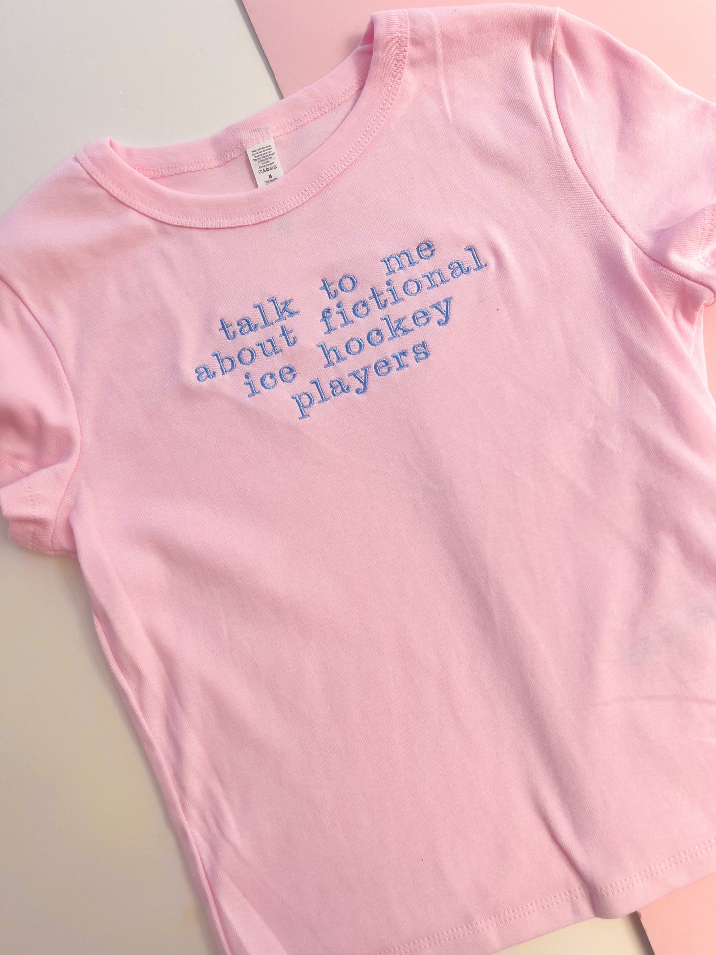 talk to me about fictional ice hockey players embroidered baby tee